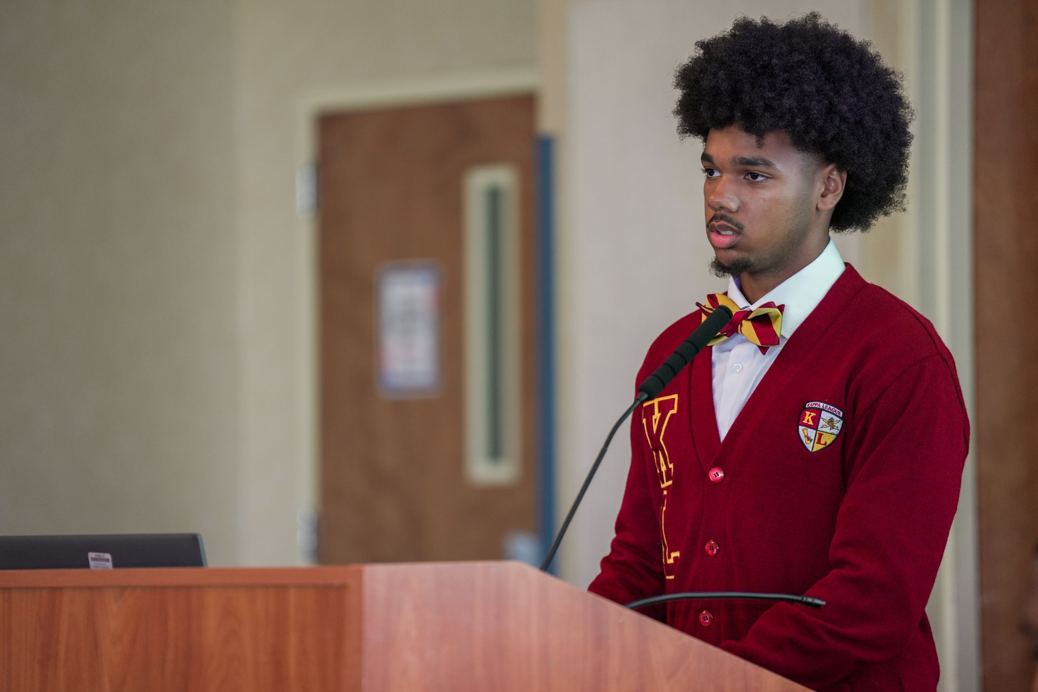 Kappa League member speaking at podium
